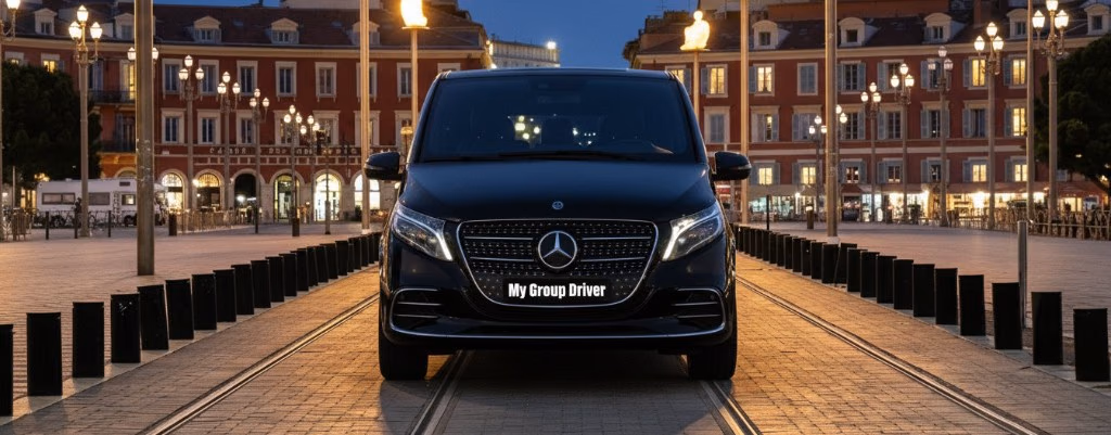Private chauffeur Nice: black Mercedes V-Class at night on Place Masséna